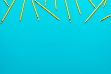 Keskinleştirilmiş kalemlerin üst görünümü turkuaz mavi arkaplan üzerinde kopya alanı ile