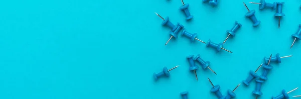 Top view of lots of push pins over blue backgound — Stock Photo, Image