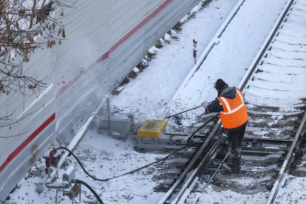 the railway worker cleans a railway track