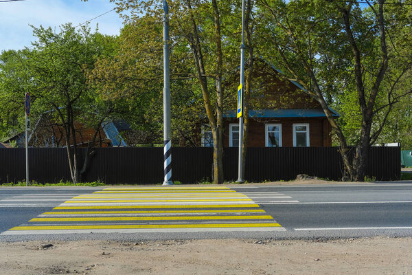 country house near the road near the pedestrian crossing