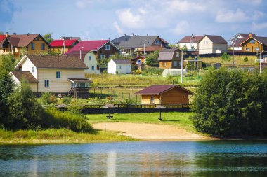 Tula region, Russia - September, 4, 2019: country landscape with the image of a village on a lake bank in Tula region, Russia