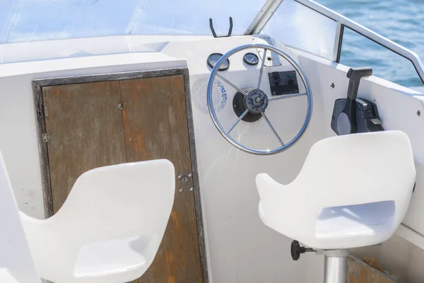 image of a steering wheel on a motor boat