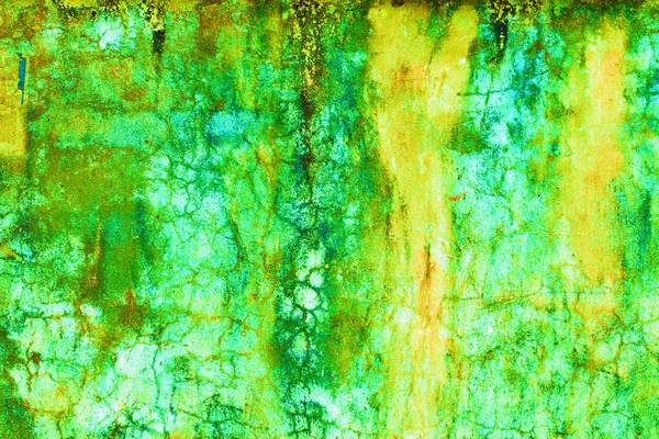 Pintura vieja verde y amarilla sobre suelo de hormigón — Foto de Stock