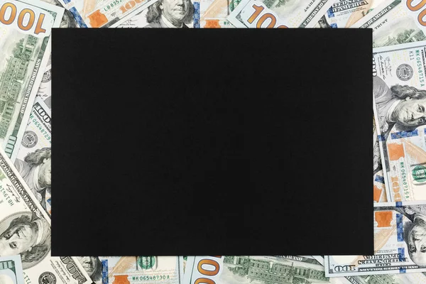 Blank black paper on background of dollar bills