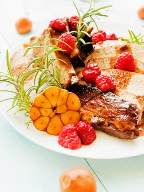 Kızarmış domuz kaburga ahududu ve biberiye ile. Sığ dof.