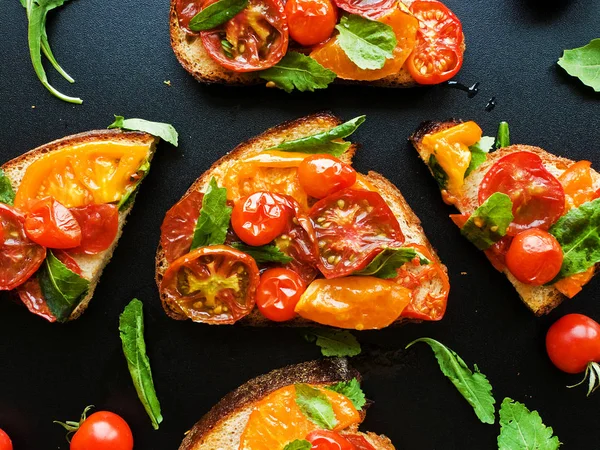 Stock image Toasts with different kinds of tomatoes. Shallow dof.