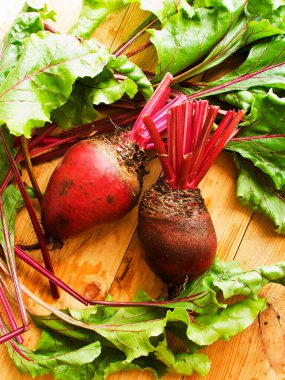 Tahta arka planda taze pancar kökleri. Sığ dof.