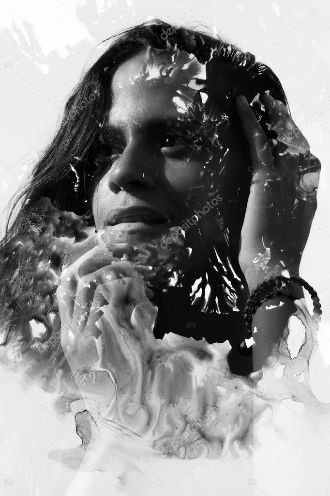 Ocean, beach summer look, relaxed with wave like texture surrounding her face, creating an impressive visual effect of her dissolution as she gently touches her face and hair with her hands