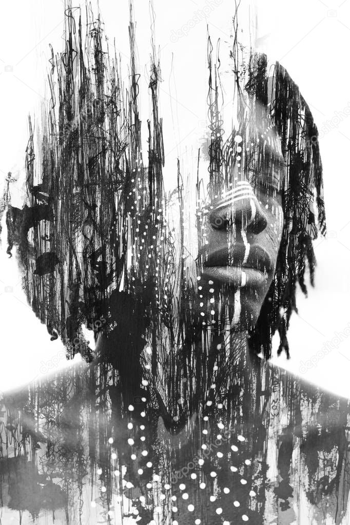 Double exposure of African man with traditional style face paint dissolving behind black ink lines, Paintography 