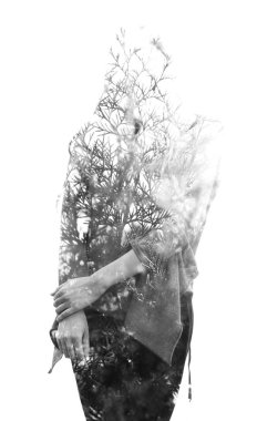 Double exposure of a young long haired woman blended with branch
