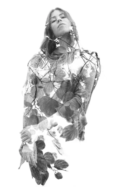 Double exposure of a young long haired woman blended with branch — 图库照片