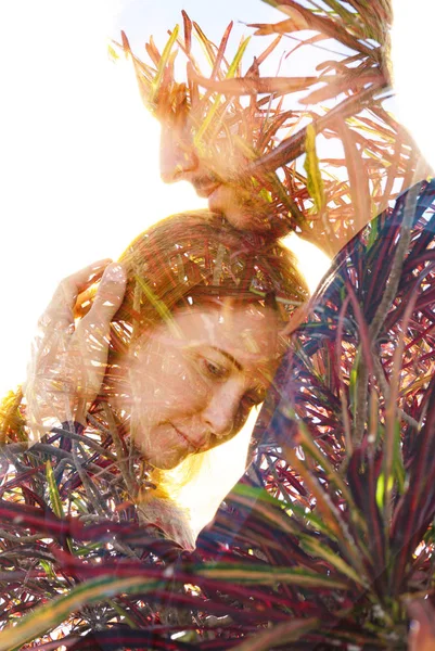 Double exposure of a couple embracing combined with vibrant lush — Stock Photo, Image