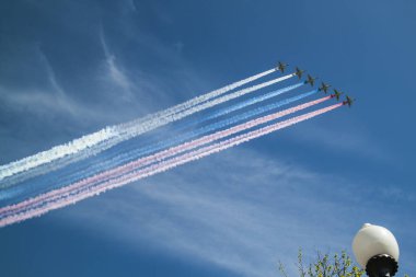 MOSCOW, RUSSIA - May 9, 2018 - Six attack planes Su-25 let out a loop in the form of the Russian flag on the military parade devoted to the 73rd anniversary of a Victory in the great Patriotic war clipart