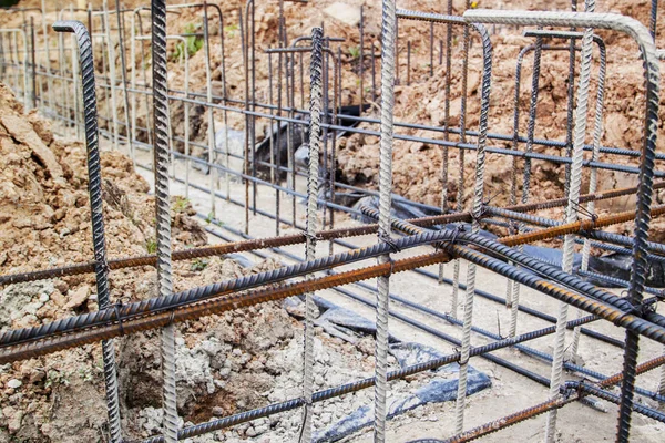 Reinforcement of concrete with metal rods connected by wire. Preparation for pouring the Foundation — Stock Image Reinforcement Concrete Metal Rods Connected Wire Preparation Pouring Foundation Royalty Free Stock Photos