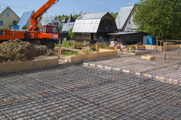 Concrete pump in anticipation of pouring concrete in a prepared 