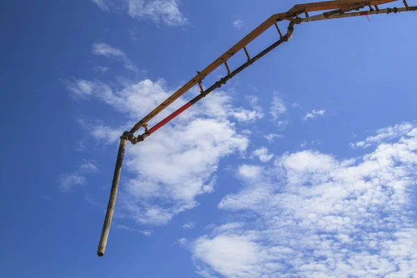 Blue sky with white clouds and pipe of concrete pump — Stock Photo, Image