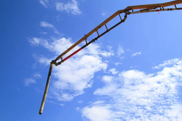 Blue sky with white clouds and pipe of concrete pump — Stock Photo, Image