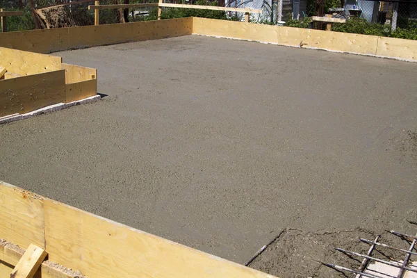 concrete slab of foundation with wooden formwork