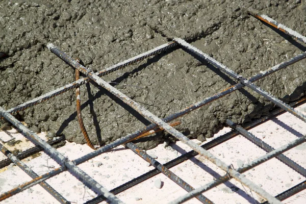 Close up view of pouring concrete into prepared place with reinf — Stockfoto