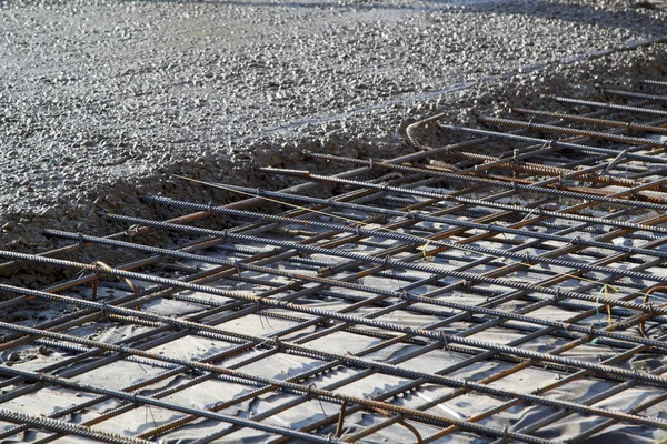 Pouring concrete into prepared place with reinforced metal frame — Stock Photo, Image