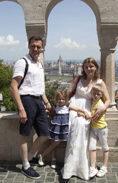 mutlu aile iki çocuk ile seyahat kamera bakmak gülümseyerek