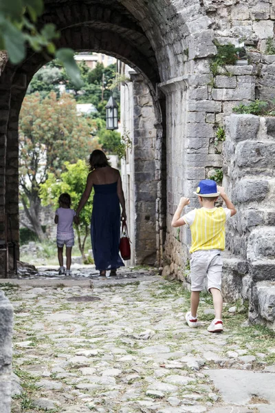 Kleiner Junge mit blauem Hut holt seine Mutter und Schwester ein — Stockfoto