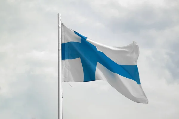 Bandiera della Finlandia su un cielo blu con sfondo nuvole — Foto Stock