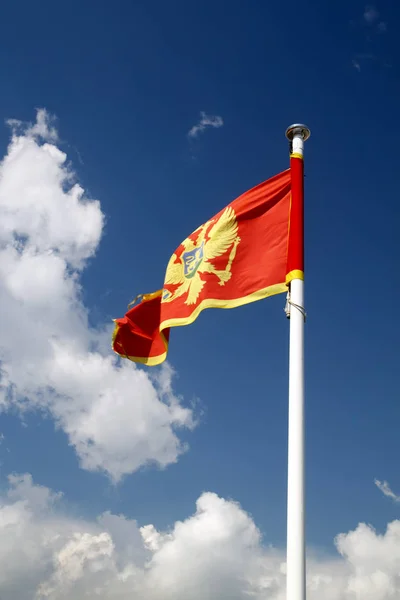 Flag of Montenegro against blue sky — Stock Photo, Image