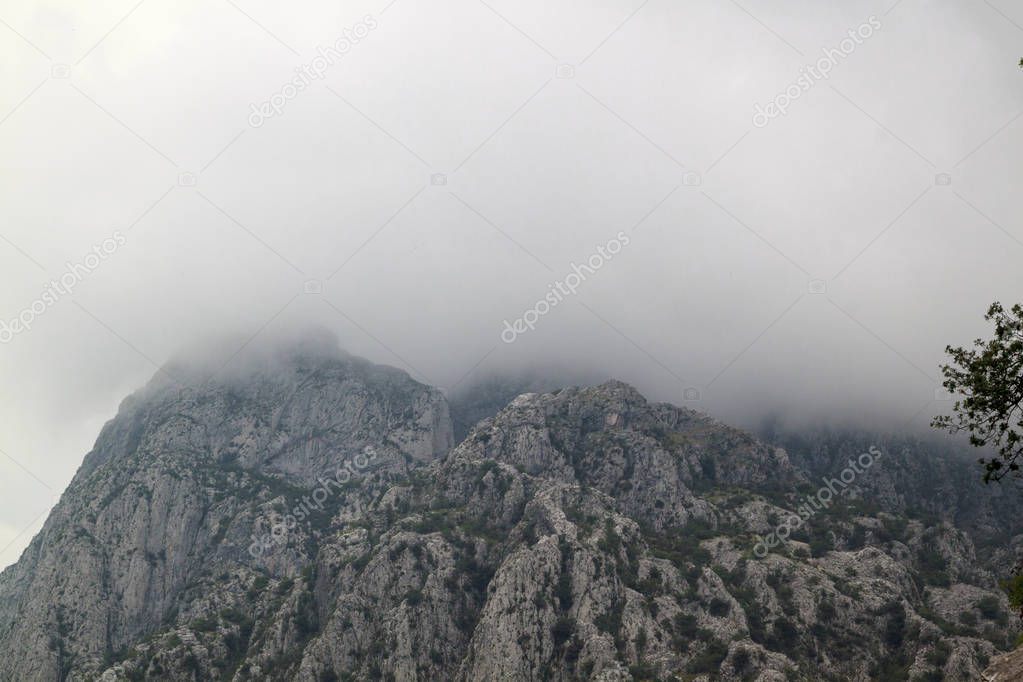 Mountains with white clouds on a blue sky background