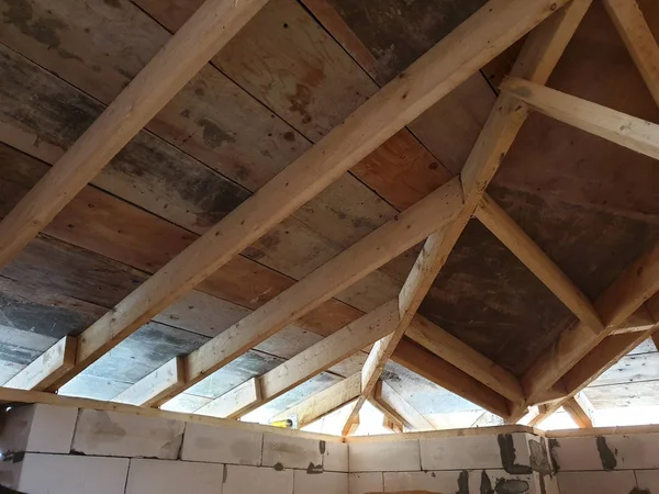 View of wooden rafters when installing roof on construction of house — Stock Photo, Image