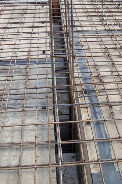 Close up view of reinforcement of concrete with metal rods connected by wire. Preparation for pouring the Foundation — Stock Photo, Image