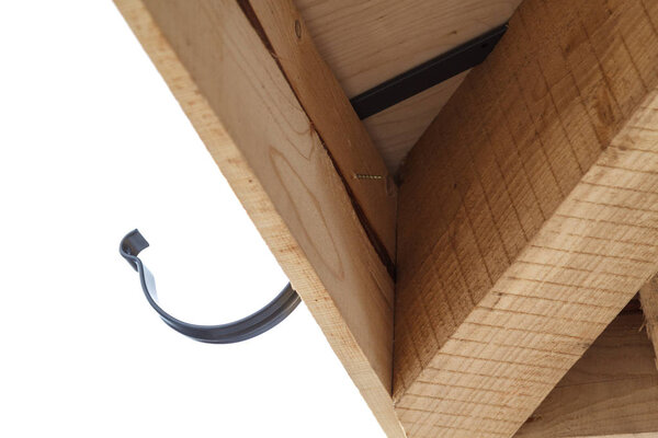 close up view of house under construction with holder for gutter drainage system of roof