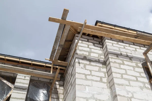 Nahaufnahme von Gerüsten und im Bau befindlichem Haus mit Halterungen für Dachrinnen — Stockfoto