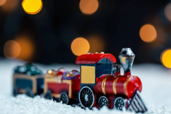 The Christmas train in the snow on bokeh background