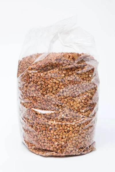 Buckwheat in transparent bag on white background — Stock Photo, Image