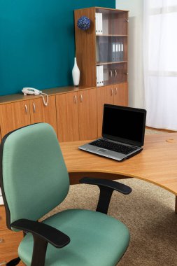 Modern bir ofiste dizüstü bilgisayarı olan bir iş yeri