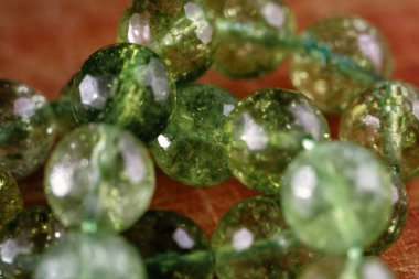 Macro image of natural mineral rock specimen in form of round bead from green jade gemstone clipart