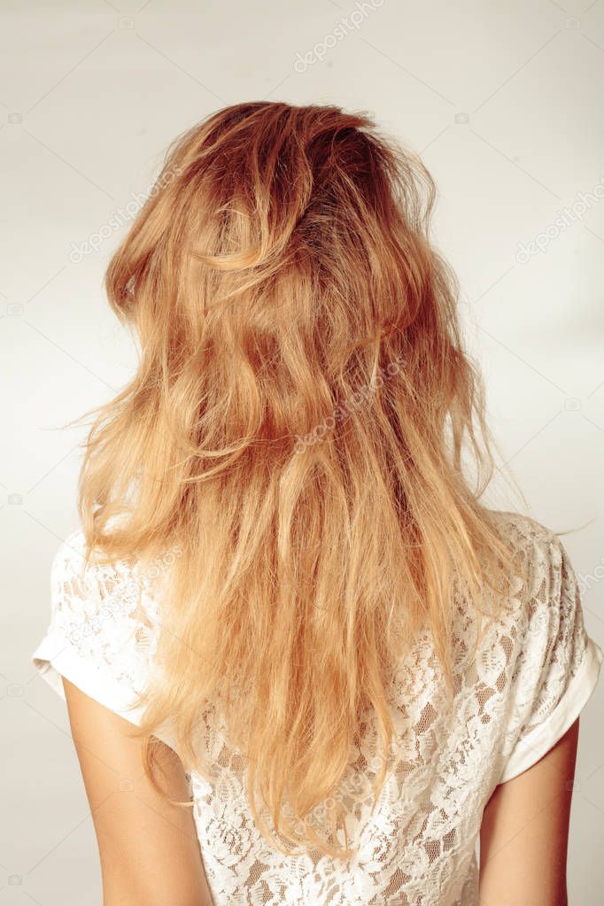 Back view of woman with beautiful long blonde hair