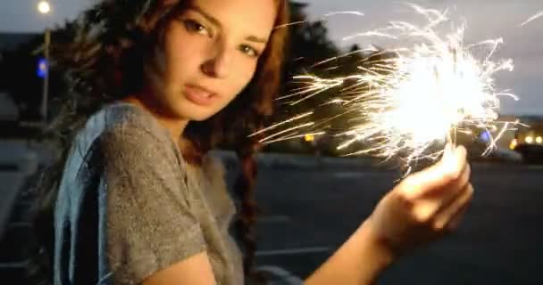 Portrait of a model looks happy with sparklers in her hands. Close up — Stock Video