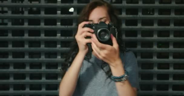 Teen Age Girl Taking Photo By Vintage Film Camera In Front Of Metal Fence — Stock Video