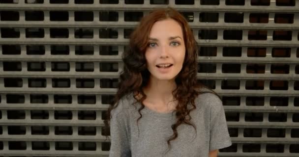 Happy Teen Girl Smiling In Front Of Metal Fence Of Restricted Area — Stock Video