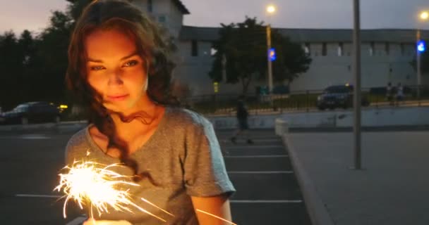 Movimento lento da menina se movendo em câmera lenta com sparklers em suas mãos — Vídeo de Stock