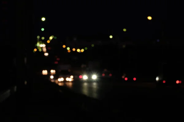 Evening cityscape with lights of cars on road — Stock Photo, Image