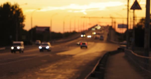 Traffic of commuters cars in sunset time on overpass. Yellow sunset sky as background — Stock Video