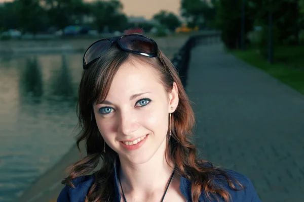 Redhead girl smiling near river in night time. — Stock Photo, Image