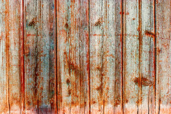 Textur der verwitterten Holzwand. Alter Bretterzaun aus senkrechtem Flachbrett mit Farbflecken — Stockfoto