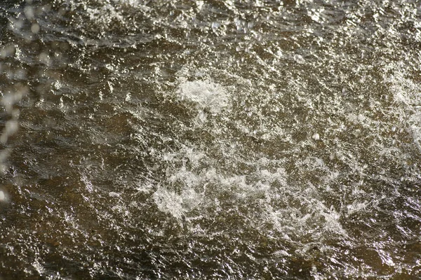 Water with ripples made by falling drops. — Stock Photo, Image