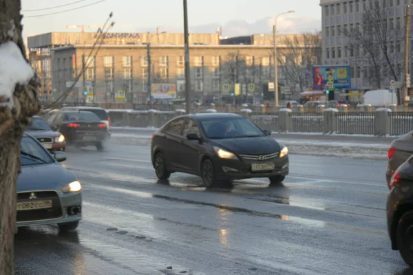 St.Petersburg Russia, 24 Feb 2016: Streets with cars covered with water mixed with snow after night snowfall — Stock Photo, Image