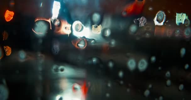 Wet Window With Blurred Lights Behind — Stock Video