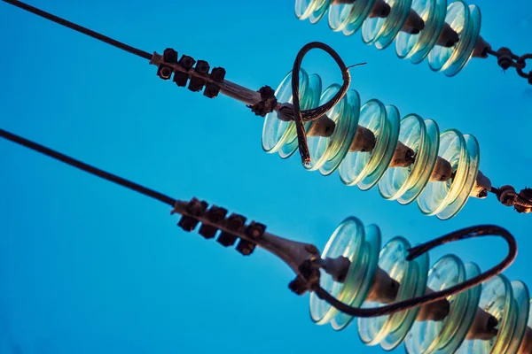 Closeup of glass insulators with high woltage wires — Stock Photo, Image